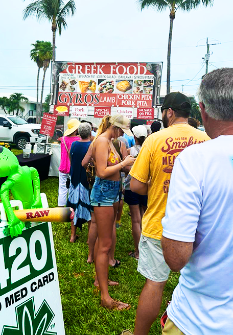 people inline for a food stand