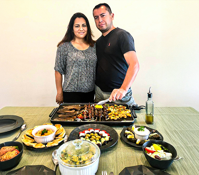 people standing on the grass in fornt of a garden tent